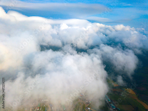 Top view Aerial photo from flying drone over white clouds ,Mountains and winding road mountain paths exciting steep at Phu Thap Boek ,Phetchabun Province,Thailand,ASIA.