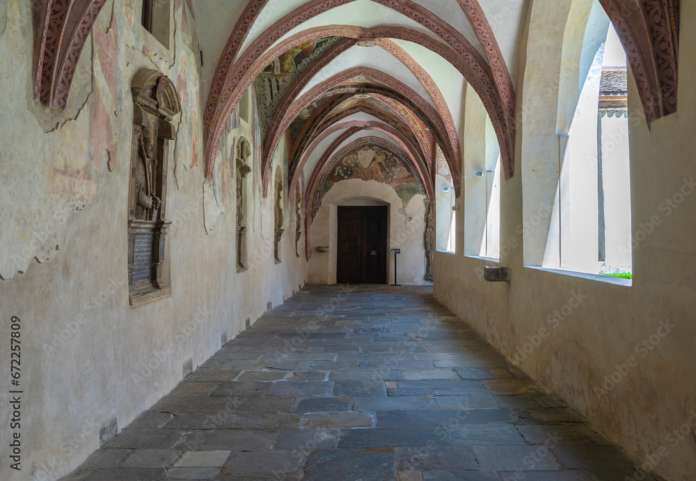 Novacella Augustinian Abbey. The Gothic cloister with from valuable frescoes, Brixen (Bressanone), South Tyrol, northern Italy, Juni 12, 2023