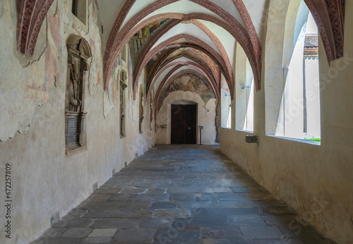 Novacella Augustinian Abbey. The Gothic cloister with from valuable frescoes, Brixen (Bressanone), South Tyrol, northern Italy, Juni 12, 2023