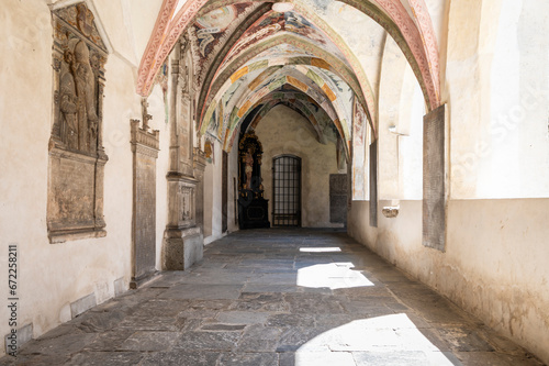 Novacella Augustinian Abbey. The Gothic cloister with from valuable frescoes, Brixen (Bressanone), South Tyrol, northern Italy, Juni 12, 2023