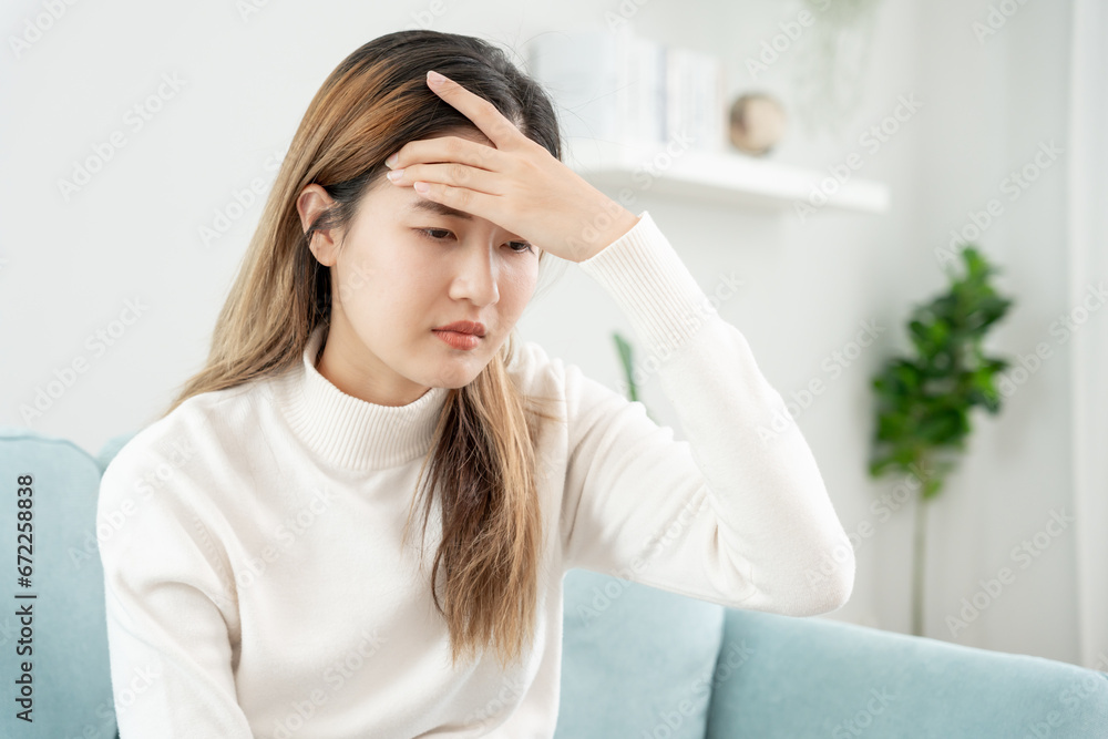 Headache, female having migraine pain, bad health, Asian woman feeling stress and headache, Office syndrome, sad tired touching forehead having migraine or depression, irritated girl, sadness grief Headache, female having migraine pain, bad health, Asian woman feeling stress and headache, Office syndrome, sad tired touching forehead having migraine or depression, irritated girl, sadness grief