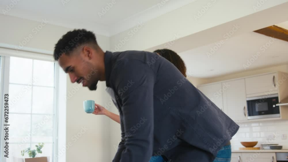 Couple taking coffee break from unpacking boxes in new home on moving day - shot in slow motion Couple taking coffee break from unpacking boxes in new home on moving day - shot in slow motion