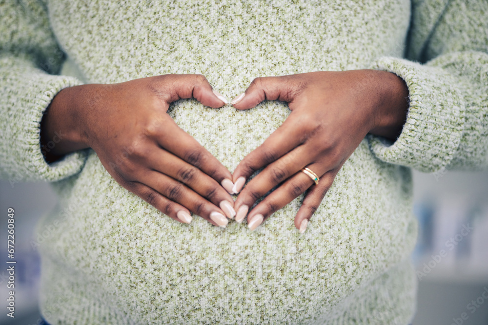 Pregnancy, closeup and woman with a heart shape on her maternal belly for care and motherhood. Health, zoom and African pregnant female person hands on stomach with a love sign or emoji for her baby. - obrazy, fototapety, plakaty 