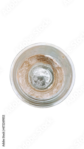 A top-down view of an empty plastic glass wrapping with brown tissue paper.
