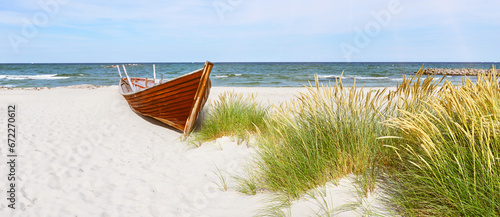 Fototapeta Naklejka Na Ścianę i Meble -  Sandy beach with dunes on the Baltic Sea with old wooden boat - Baltic Sea coast