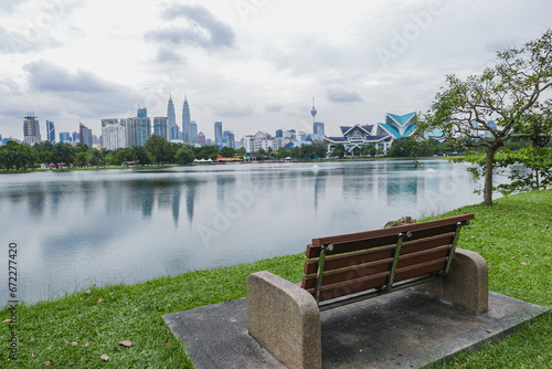 Canvas Print Park bench overlooking Titiwangsa Lake and Kuala Lumpur Skyline