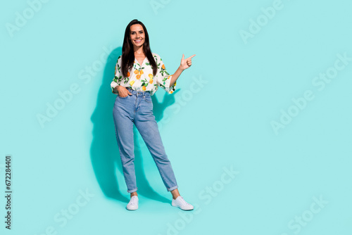 Full size photo of good mood woman dressed flower print blouse indiacting at sale empty space isolated on turquoise color background photo