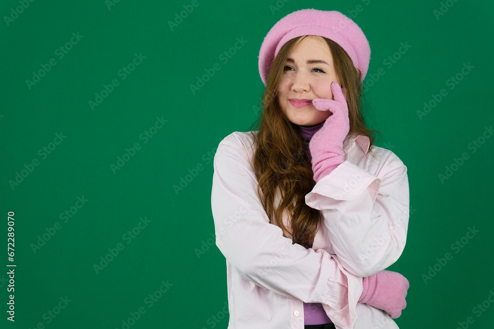 young girl woman with a pink beret on her head France fashion on a green background chromakey. different emotions pink jacket gloves long brown hair. pink winter autumn knitted gloves on hands young girl woman with a pink beret on her head France fashion on a green background chromakey. different emotions pink jacket gloves long brown hair. pink winter autumn knitted gloves on hands