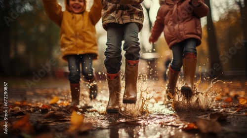 Happy children having fun in rubber boots jumping in a puddle