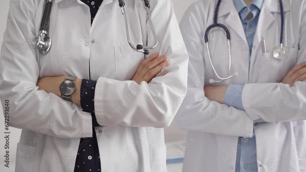 Doctor use the clipboard for making medication notes while another physician works in the background. Medicine concept Doctor use the clipboard for making medication notes while another physician works in the background. Medicine concept