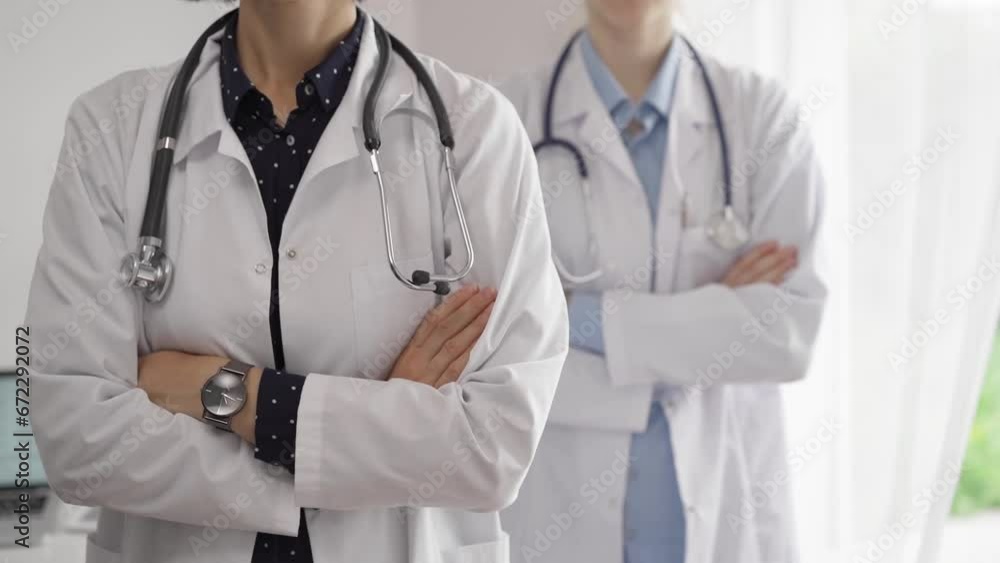 Doctor use the clipboard for making medication notes while another physician works in the background. Medicine concept Doctor use the clipboard for making medication notes while another physician works in the background. Medicine concept