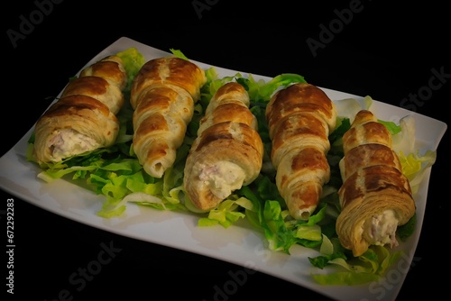 Closeup of freshly-baked croissants with fillings on a plate