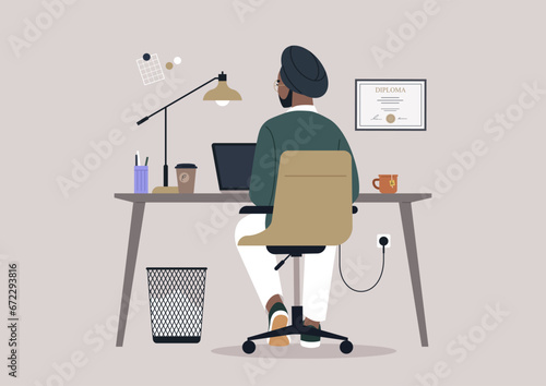 A young Indian character diligently using their computer at a desk, viewed from behind
