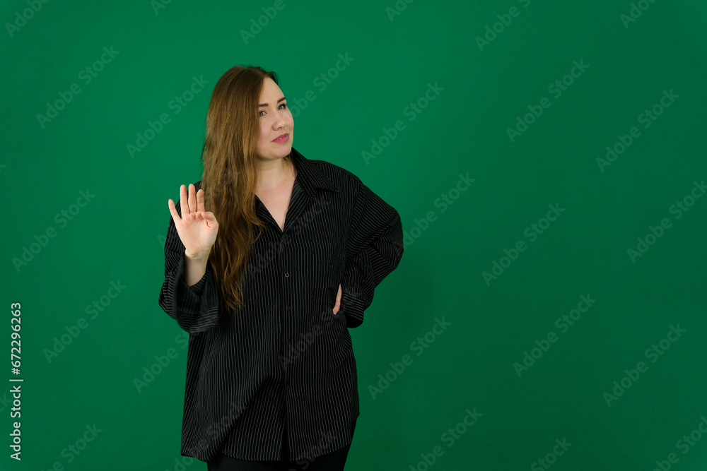 woman on a green background chromakey in a black striped mens shirt different emotions facial expression close-up advertising space for text clean. kind eyes woman on a green background chromakey in a black striped mens shirt different emotions facial expression close-up advertising space for text clean. kind eyes