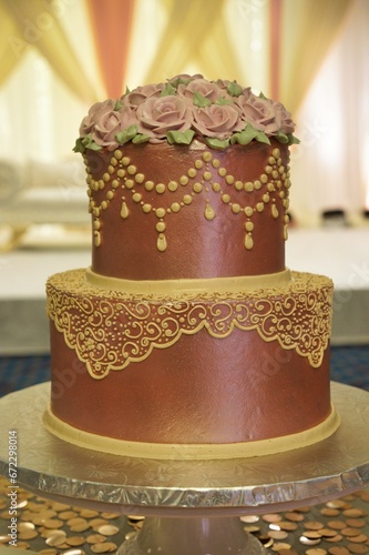 the two tier cake has different colors and flowers on it