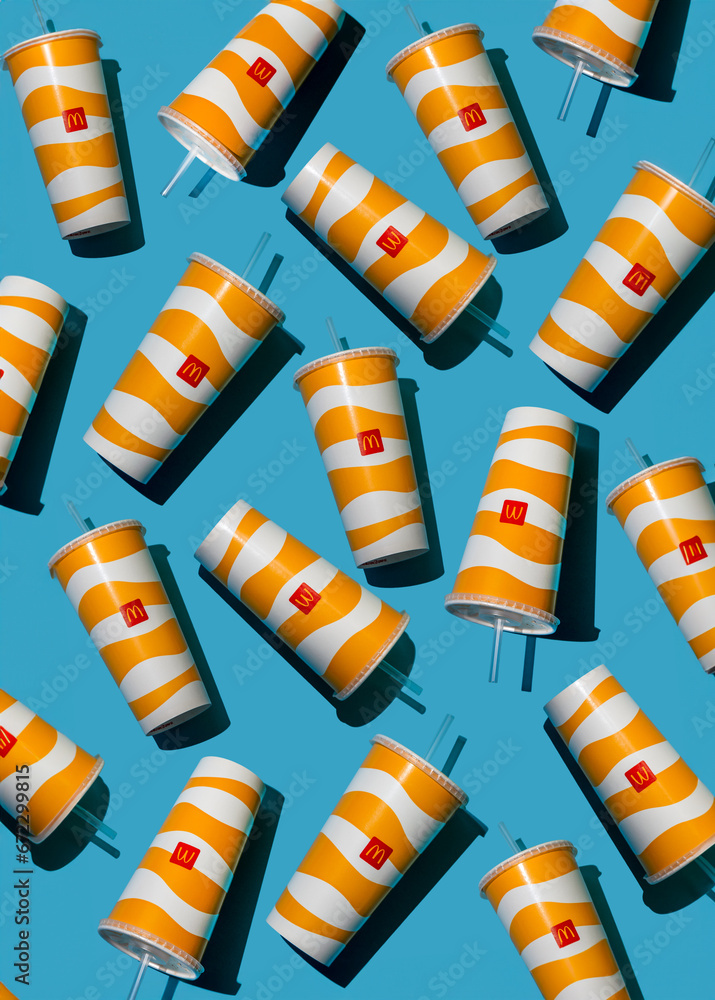 Yellow glass of McDonald's. Paper cup with lid. Takeaway drink ...