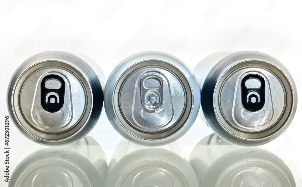 Three aluminum can on a plane surface