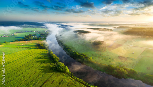 Aerial view of beautiful landscape of foggy river and green fields
