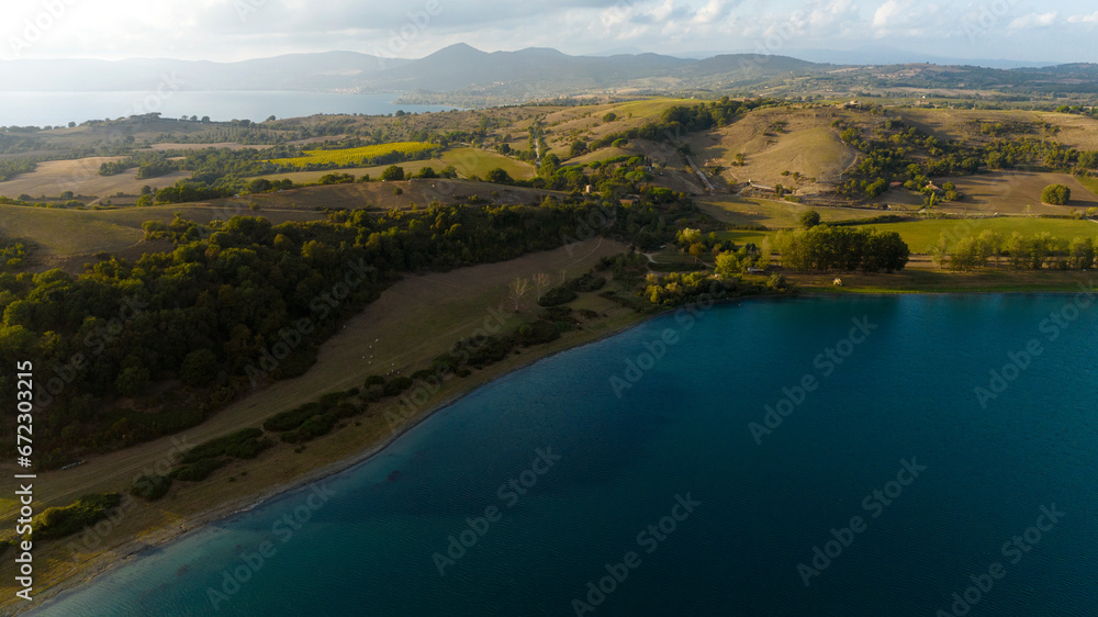 Aerial view of Lake Martignano, originally called Lake Alsietino. It is an endorheic lake of volcanic origin located in Lazio, Italy. In background there is Lake Bracciano.