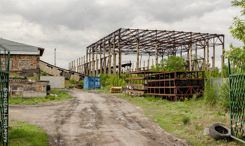 Old factory with metal structures against the background of a cloudy sky. Kazakhstan. Old factory with metal structures against the background of a cloudy sky. Kazakhstan.