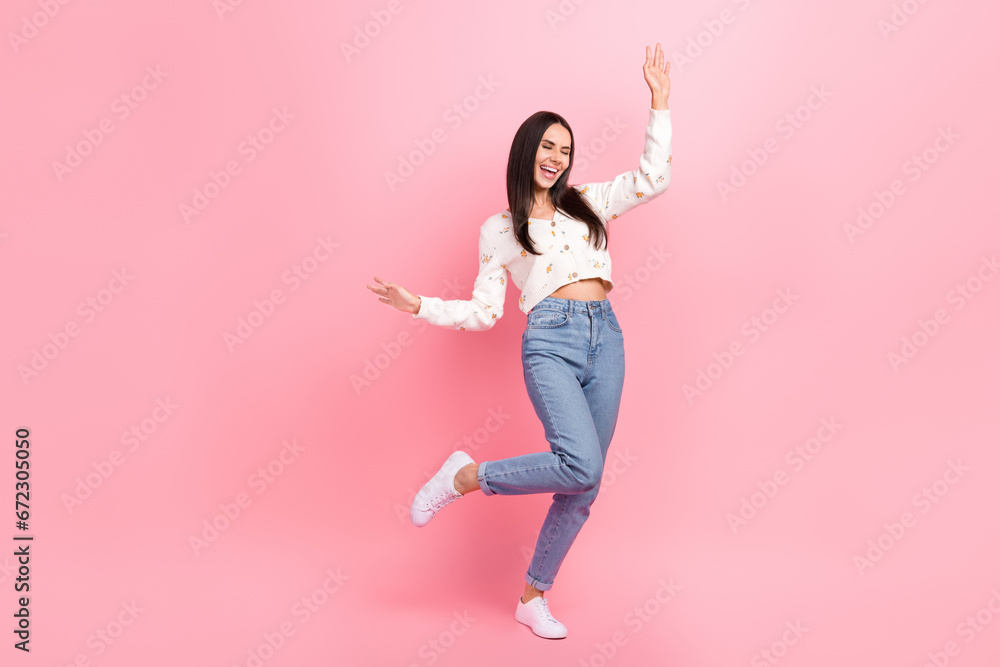 Full length photo of dreamy carefree lady wear white cardigan dancing having fun empty space isolated pink color background