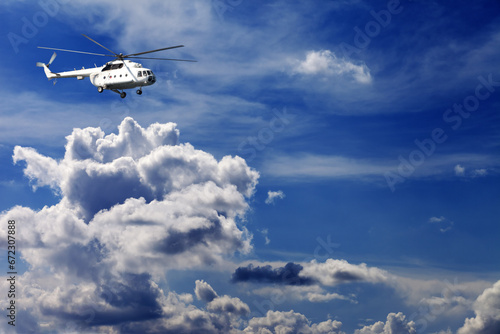 Helicopter in blue sky with clouds
