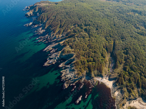 Aerial view of the rocky, wild coast of the Black Sea in Bulgaria, with cliffs, beaches, and green forests