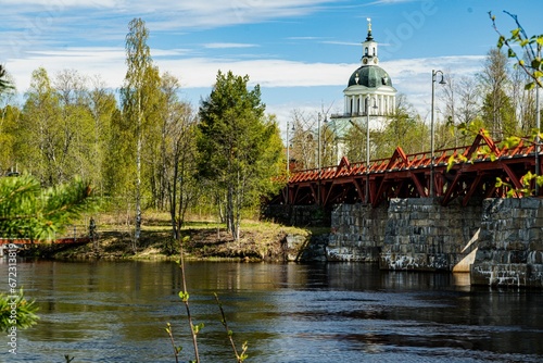 Picturesque scene of a bridge suspended over a tranquil river in Skelleftea, Sweden