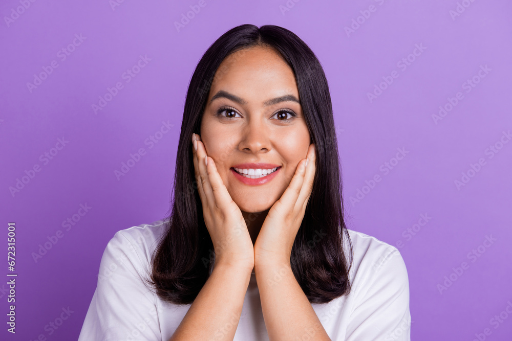 Photo of adorable positive lady touch cheeks hands cheeks satisfied enjoying perfect flawless skin isolated on purple color background Photo of adorable positive lady touch cheeks hands cheeks satisfied enjoying perfect flawless skin isolated on purple color background