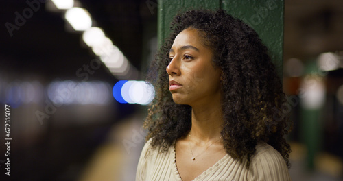 Young black woman serious sad face at subway platform