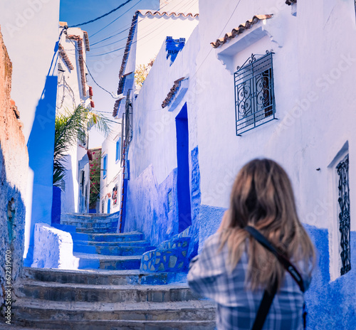 tourist walking on the blue streets of Chefchaouen Morocco © Agata Kadar