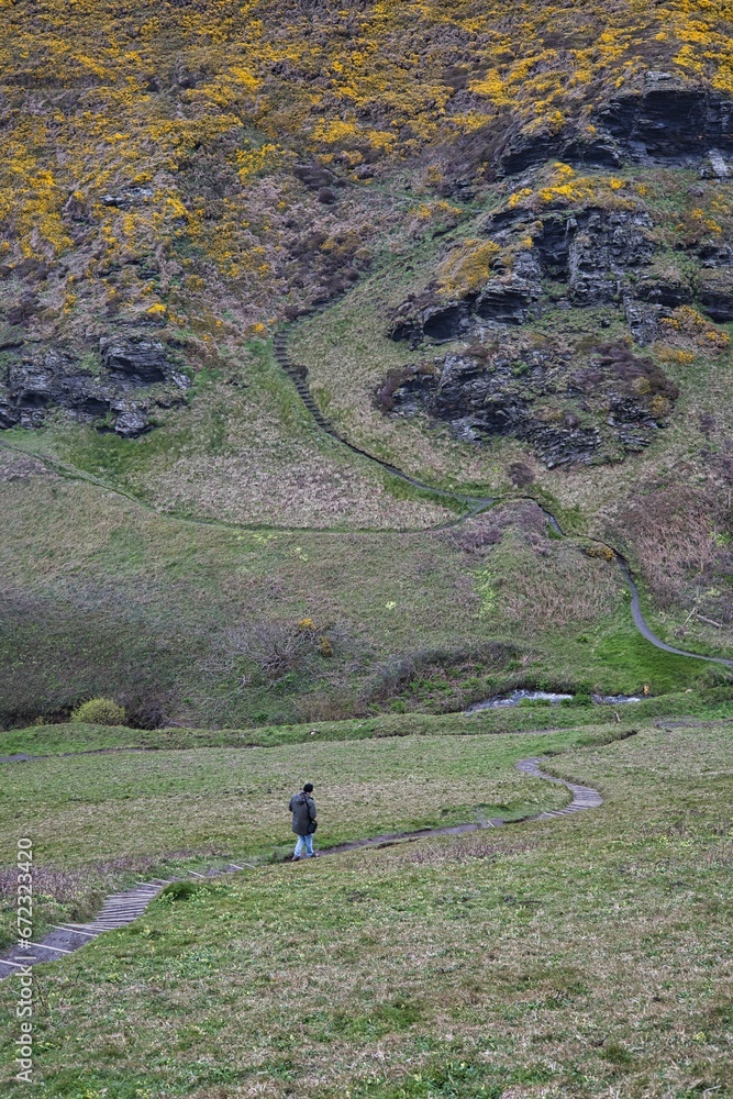 Vertical shot of a person going up stairs carved into the countryside of Bosscastle, Cornwall Vertical shot of a person going up stairs carved into the countryside of Bosscastle, Cornwall