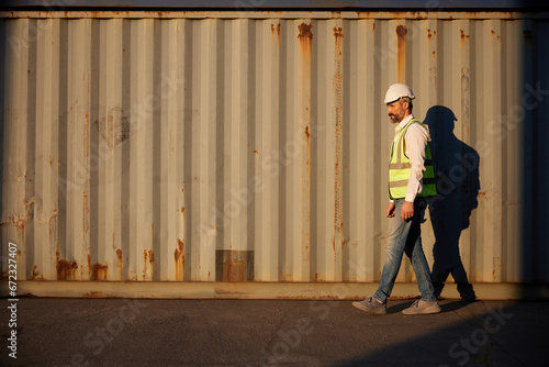 factory worker or engineer walking forward in containers warehouse storage