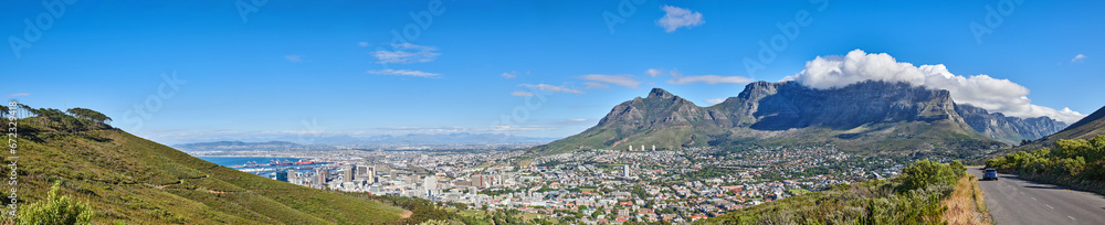 Wide angle of Cape Town and mountain landscape on a sunny day. Beautiful view of a city against a blue horizon. A popular travel destination for tourists and hikers, on Table Mountain, South Africa
