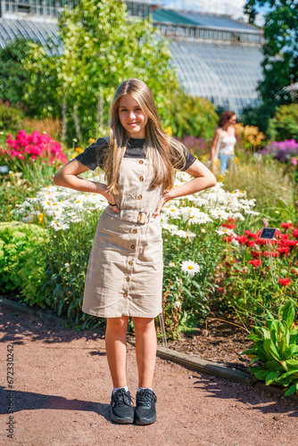 Young teen girl in colorful flower garden in Botanical Garden