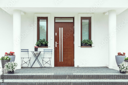 Designer entrance door to a country house. Modern design. luxurious exterior. Facade of a modern building with modern doors. photo
