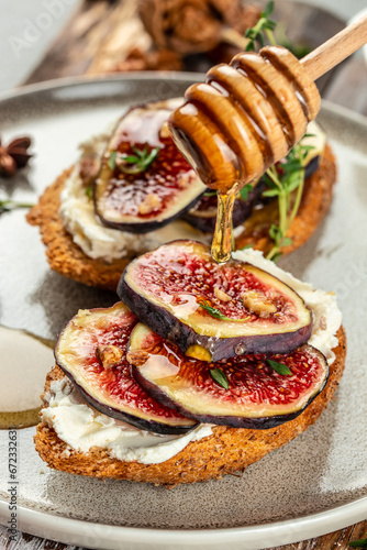 Gourmet snack, Toast bruschetta with ricotta, figs on plate vertical image. top view. copy space for text