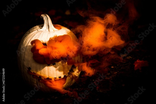 Canvas Print Spooky Jack o' Lantern carved into a pumpkin with orange-hued smoke emitting from it