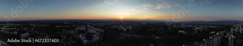 Aerial panoramic view of sunset over the bustling city © Wirestock