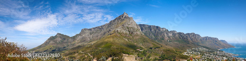 Beautiful Table Mountain with lush greenery and nearby urban city in a wide angle landscape in summer. Scenic view of the nature in South Africas popular National landmark natural tourist destination