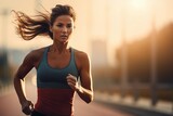 Young woman running in the street. Sports and a healthy lifestyle concept. Copy space.