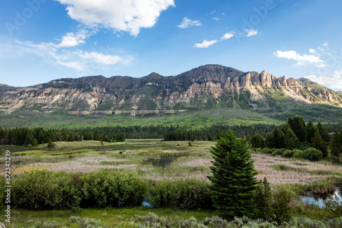 Cathedral Cliffs, hills, meadows and swamp in the northwest Wyoming wilderness of Shoshone National Forest.  photo