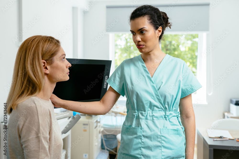 Young female african american doctor talking to sad woman patient, comforting, supporting and reassuring her. Healthcare, empathy concept. Young female african american doctor talking to sad woman patient, comforting, supporting and reassuring her. Healthcare, empathy concept.