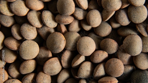 Close-up shot of an array of lentils scattered in a heap. © Wirestock