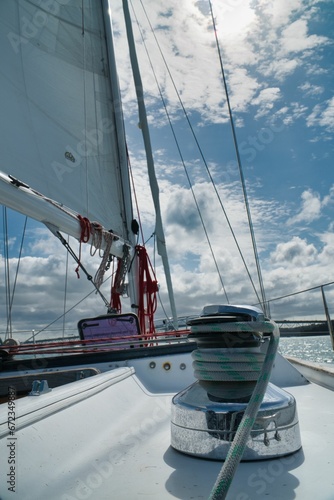 White sailboat with a large winch affixed to its port side.