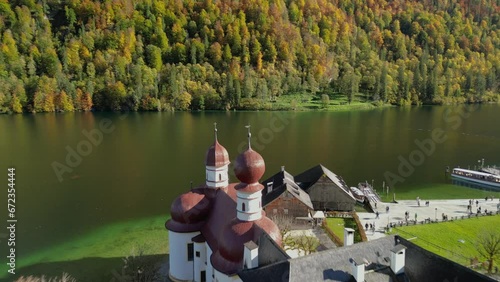 The drone aerial footage of Lake Konigsee with Sankt Bartholomae pilgrimage church and Watzmann mountain, Berchtesgadener land, Bavaria, Germany. photo