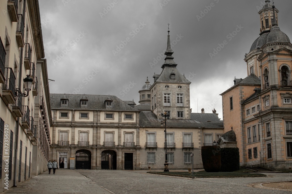 Ancient La Granja de San Ildefonso royal palace in San Ildefonso, Spain against a clouded sky