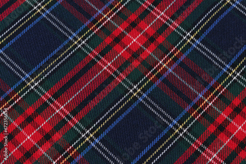 close-up of a tartan cell fabric in blue, red and green colors at an angle. mockup for your design. traditional Scottish clothing