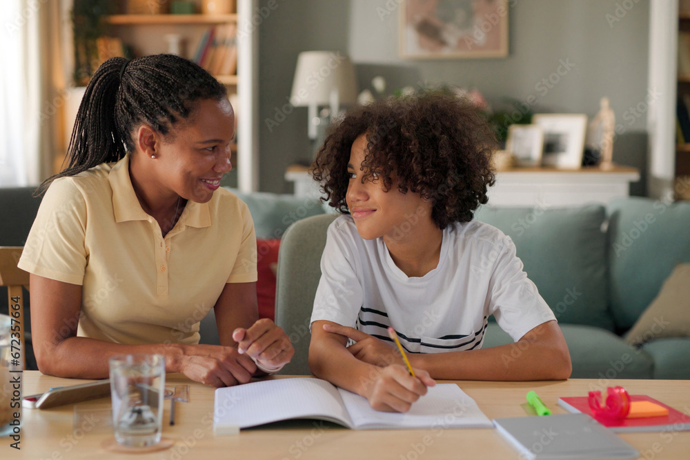 Mom helping a teenage son study for exam at home Mom helping a teenage son study for exam at home