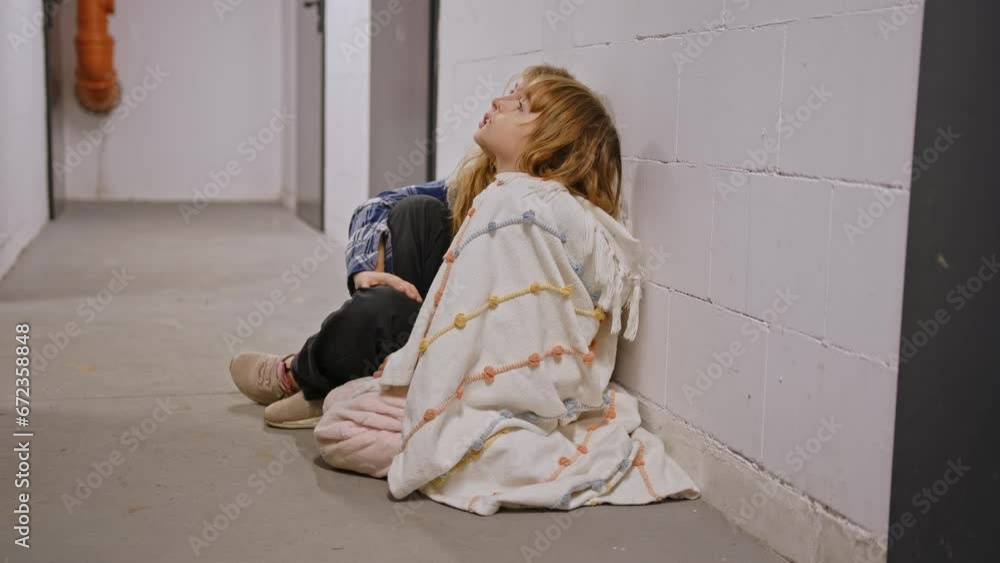 Two Scared Cowering Young Children Girls Hiding in Basement Shelter during Bombing Air Raid Bombardment Two Scared Cowering Young Children Girls Hiding in Basement Shelter during Bombing Air Raid Bombardment